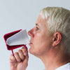 A side view of a woman drinking from a red Ornamin Wide Base Thermal Mug with Internal Cone