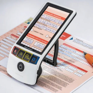 the image shows the eschenbach smartlux 12.7 cm (5 inches) digital magnifier being used to help someone magnify a form they are filling in