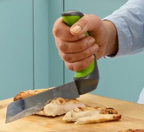 the image shows the Easi-Grip kitchen carving knife being used to carve meat