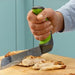 the image shows the Easi-Grip kitchen carving knife being used to carve meat