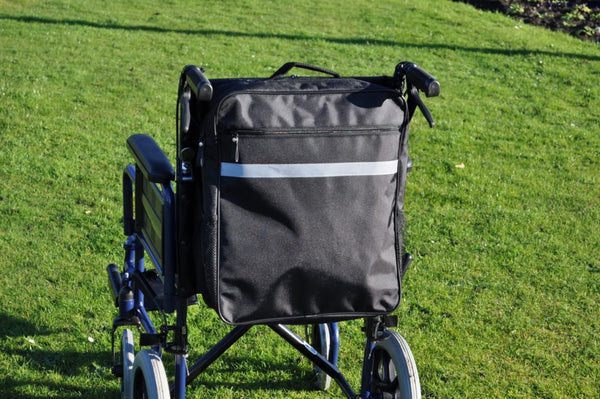 shows the Splash Wheelchair Bag in black attached to a wheelchair