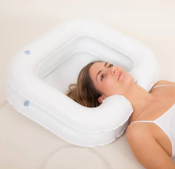 Woman lying down, her head in the Atlantis Deluxe Inflatable Shampoo Ring