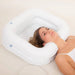 Woman lying down, her head in the Atlantis Deluxe Inflatable Shampoo Ring