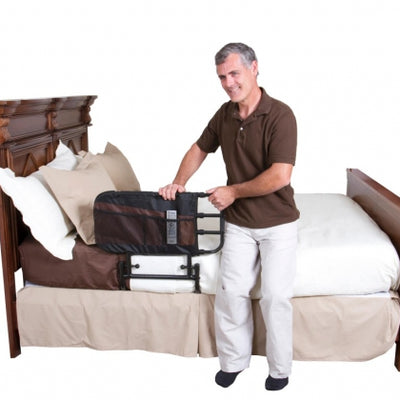 Picture of EZ Adjustable Bed Rail with Pouch from Stander on a bed with a man using it to get up