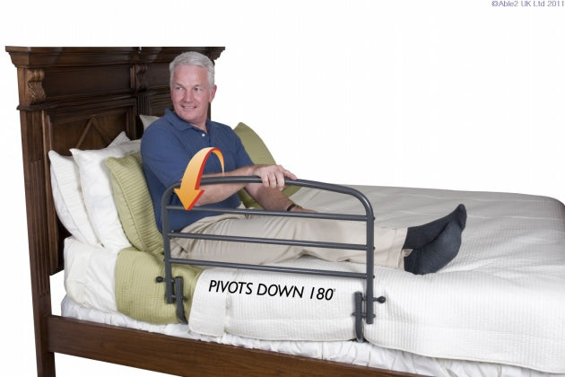 Man using the 30 Inch Safety Bed Railand a graphic overlay showing thee 180 degree pivot rail