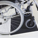 the image shows a wheelchair using a fibreglass threshold ramp
