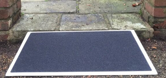 the image shows the fibreglass threshold ramp being used next to a step