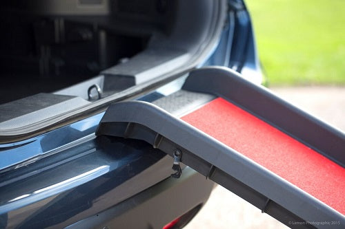 the image shows a close up of how the henry wag lightweight foldign dog ramp fits on to a car