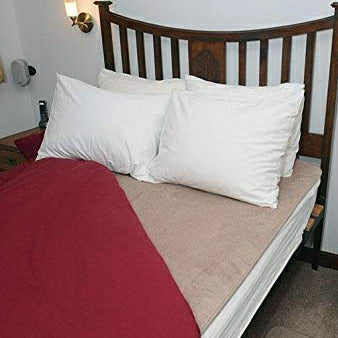 shows the bed fleece mattress topper on a double bed
