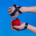 shows the velcro straps that secure the Trimmy Ball Handi Weight to a hand