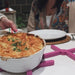 shows the purple stayput silicone trivets being used on an outdoor table 