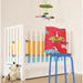 shows a blue multi-purpose adjustable stool in a baby's nursery beside a white cot