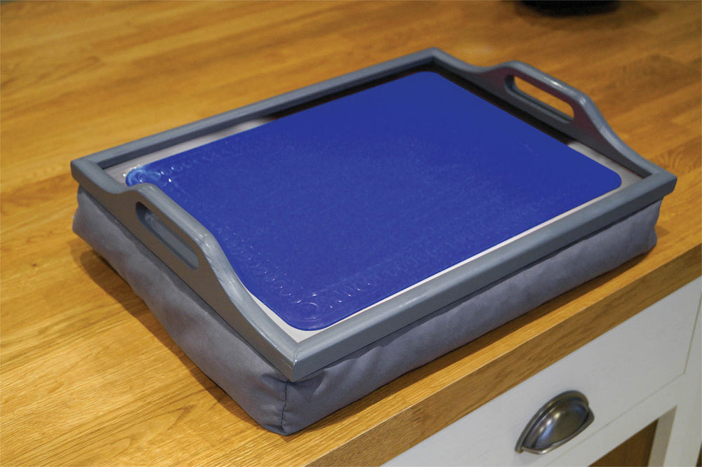shows a blue anti slip silicone mat on a tray, on a table