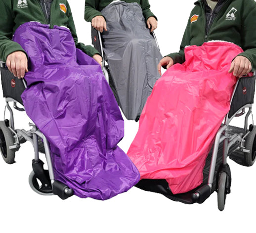 The three different colours of wheelchair cosy, purple, grey and pink