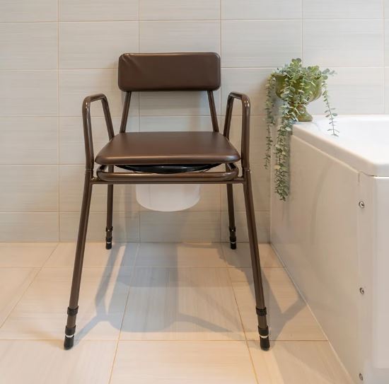 Stackable commode chair in bathroom with lid on