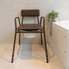 Stackable commode chair in bathroom with lid on