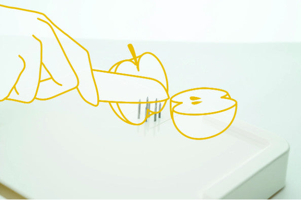 A diagram showing how the Food Workstation can be used to hold an apple securely, so it can be safely sliced