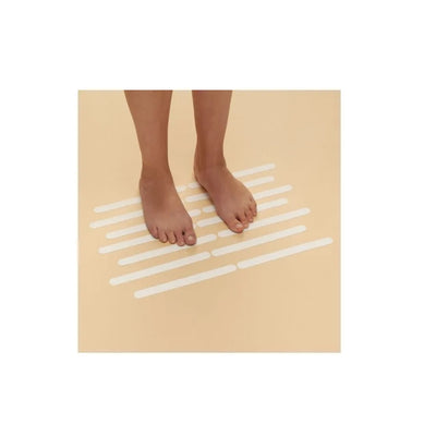 Safety Strips on bathroom floor, person standing on them to demonstrate