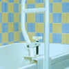 shows Homecraft bath tub grab bar foxed to the side of a bath with a  blue and yellow tiled wall in the background