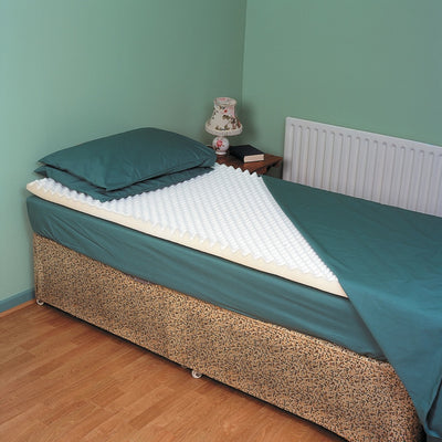shows the mattress topper on a single bed