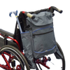 shows the Crutch/Stick Holder Bag for Wheelchairs attached to a wheelchair with a folding cane / walking stick in one of the side pockets
