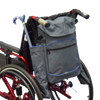 shows the crutch / stick holder bag for wheelchairs, attached to the back of a wheelchair with a folding walking stick / cane in one of the side pockets