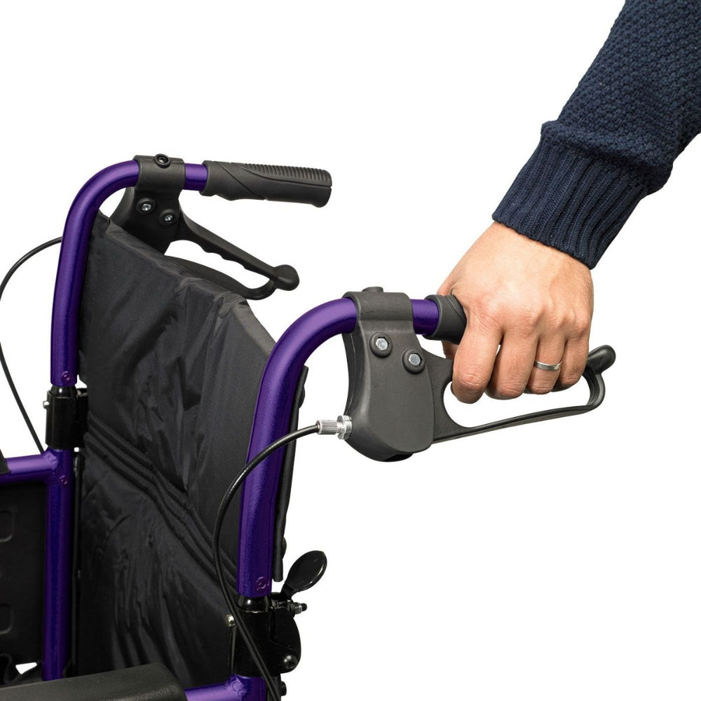 A close up of the handle and brake on a purple Days Escape Lite Wheelchair
