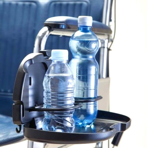 shows the double cup holder for wheelchairs fitted to the armrest of a wheelchair with two drinks bottles in the holder
