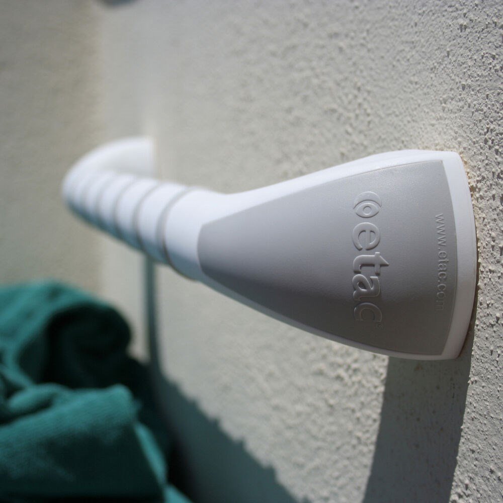 A close up of the end on an Etac Grab Bar attached to a wall