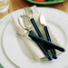 the image shows the etac light cutlery with long thin handles, on a napkin, on a plate