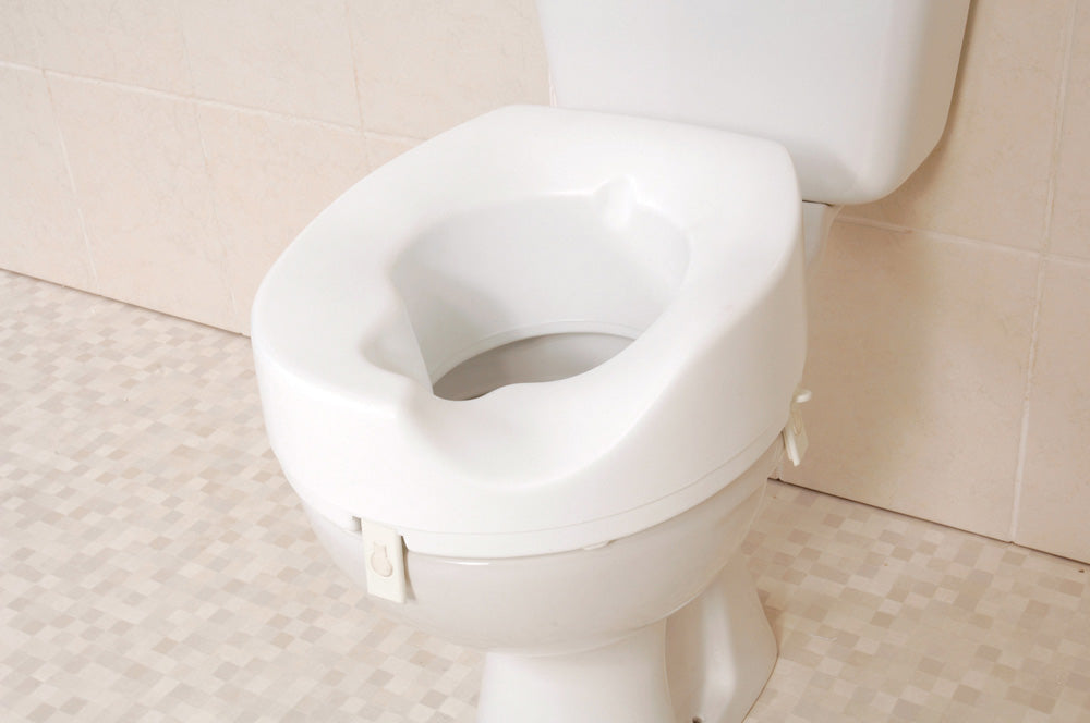 shows the melton sloped raised toilet seat, on a toilet.