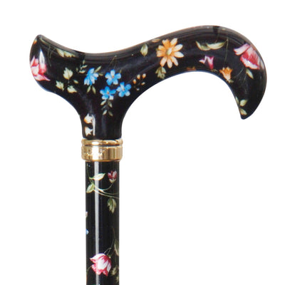 the image shows a close up of the handle on the classic canes tea party derby cane with black floral pattern