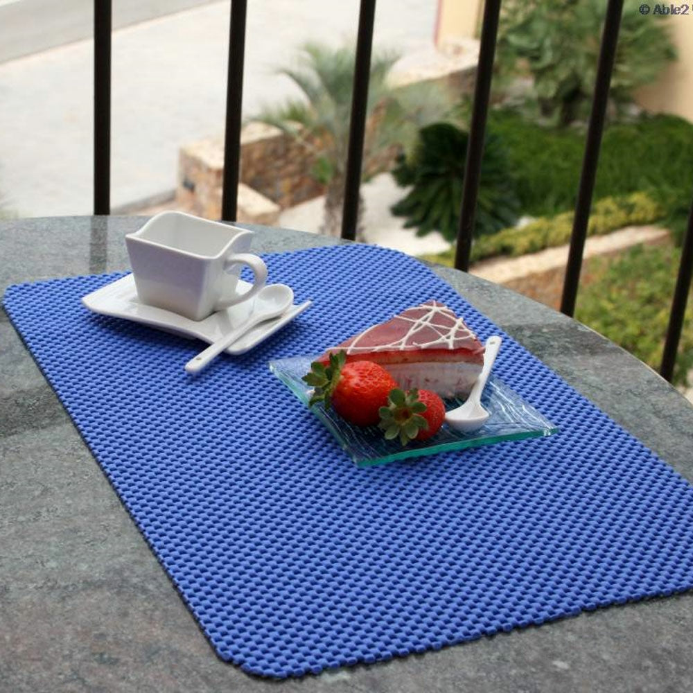 shows a plate with cake on it and a teap cup on a non-slip fabric tablemat