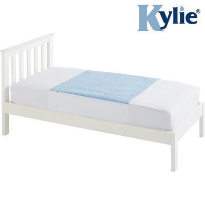 The image shows the Kylie Bed Pad in blue fitted to the mattress of a single bed