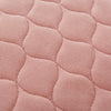 the image shows a close up of the stitching on a pink kylie bed pad