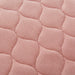 the image shows a close up of the stitching on a pink kylie bed pad