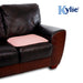 A mobility aid of the pink Kylie Chair Pad in place on a sofa cushion