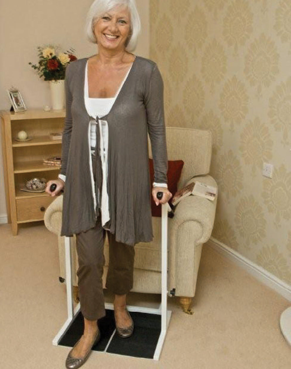 a woman using the stand easy chair riser