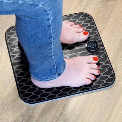 the image shows the lifemax ems foot massager in use