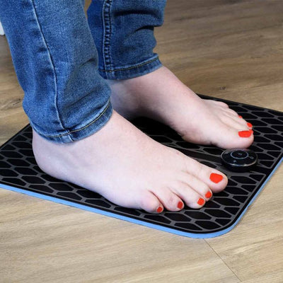 the image shows the lifemax ems foot massager being used