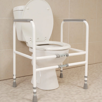 the image shows the height and width adjustable toilet fram around a toilet in a bathroom