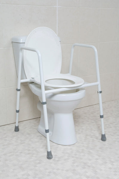 the image shows the height adjustable toilet frame with seat on a toilet