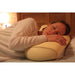 the image shows a woman lying down with her head resting on the lifemax memory bead bolster pillow