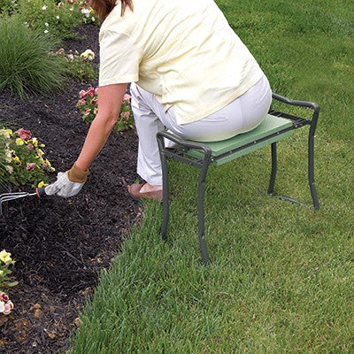 shows someone using the folding garden kneeler and stool as a stool