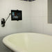 the image shows the lifemax hands free mobile device mount being used in a bathroom to hold a tablet in place at the end of a bathtub