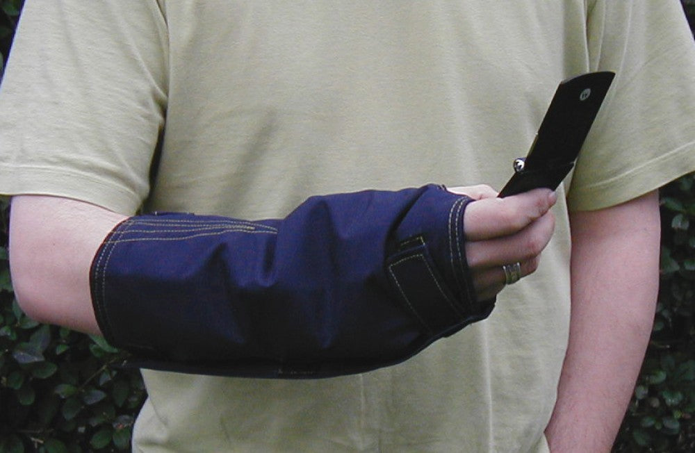 shows close-up of a man's arm and hand, holding a flip-phone and wearing an outdoor cast protector