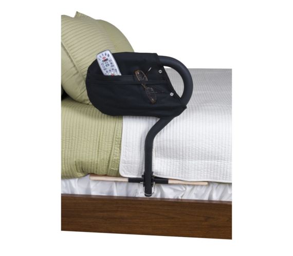 the stander bed cane on a bed with a tv remote in the pocket bag