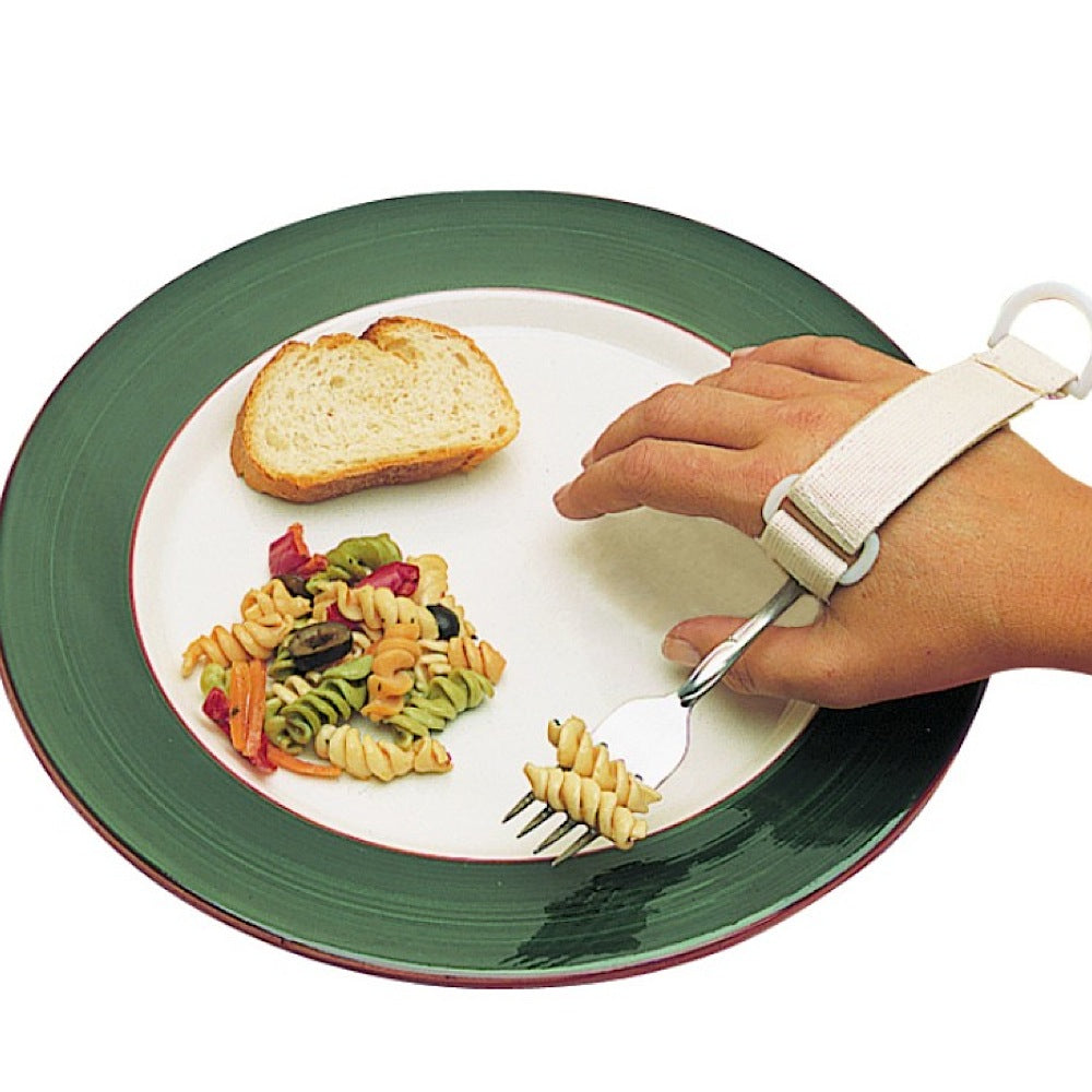 The image shows the Norco Universal Cuff being used to hold a fork to eat pasta