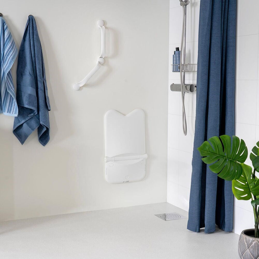 Shower chair in its upright position, in a stylish bathroom with blue accents