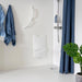 Shower chair in its upright position, in a stylish bathroom with blue accents